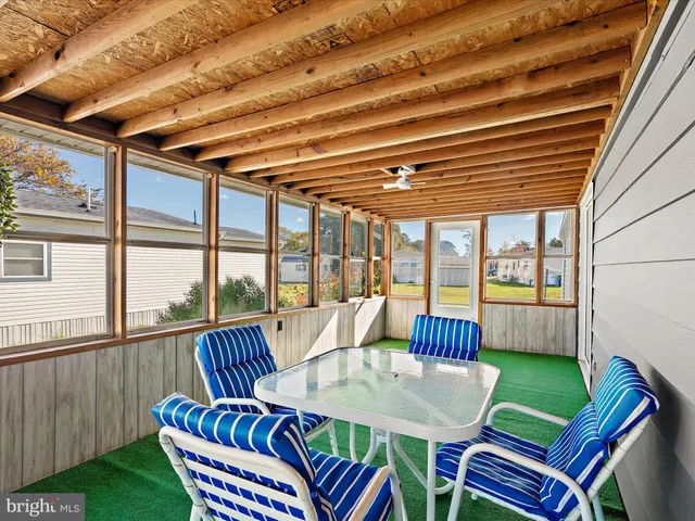 a view of a patio with a table chairs and a grill