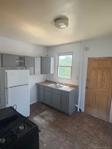 a kitchen with a refrigerator and a stove
