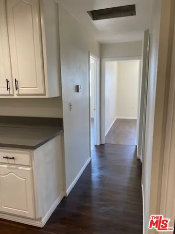 a view of hallway with wooden floor