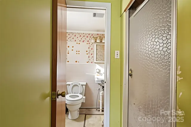 a bathroom with a toilet a sink and a shower