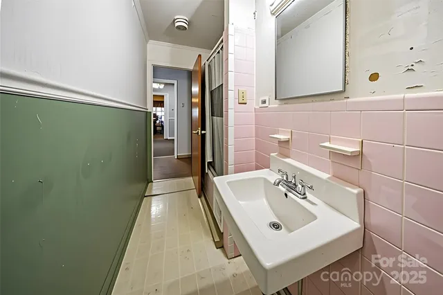 a bathroom with a sink a toilet and mirror