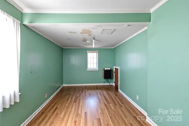 a view of a room with wooden floor