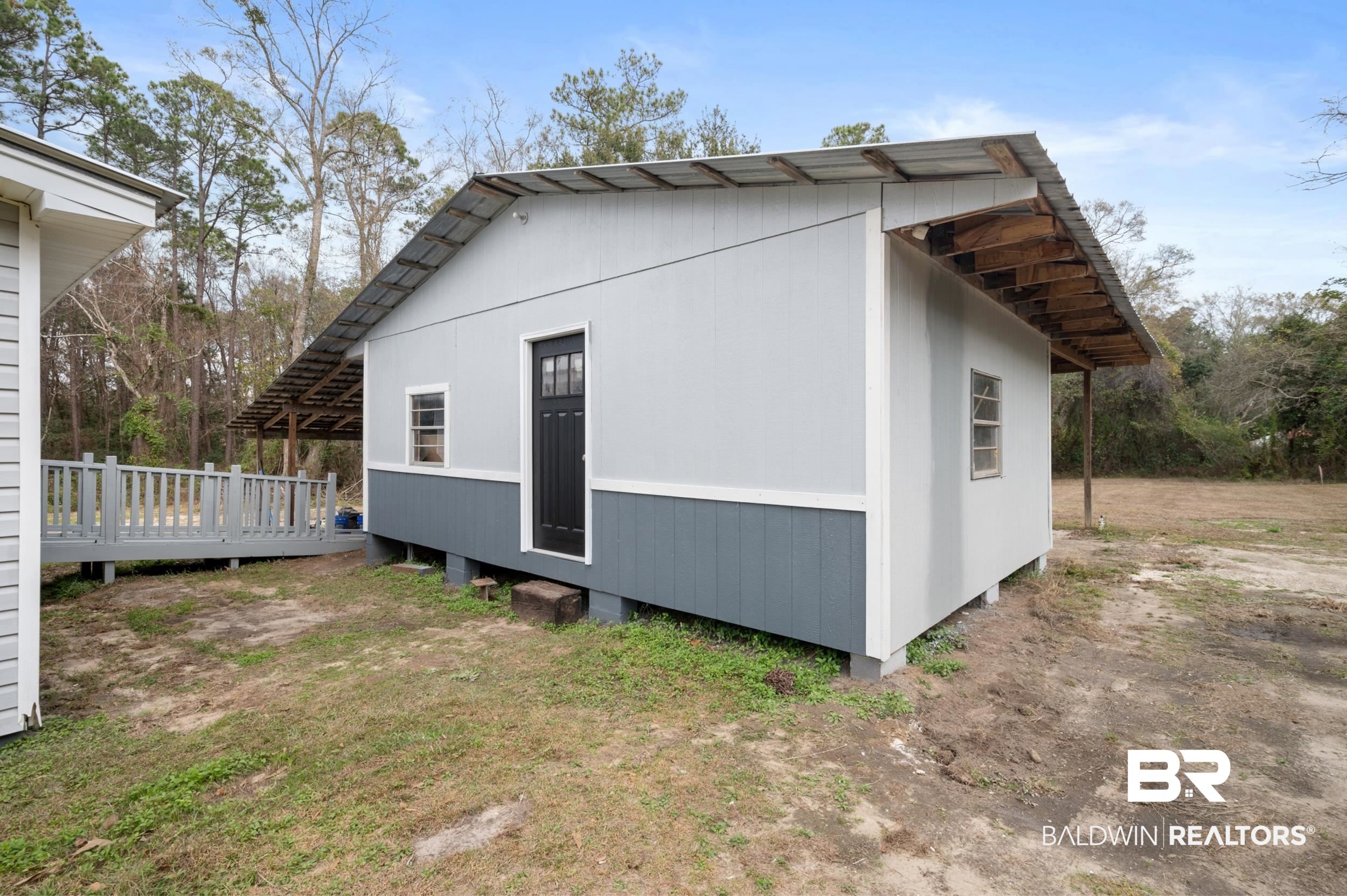 35780 Spring Road North Stapleton, AL 36578 - Photo 39 of 41 View of side of property with a wooden deck
