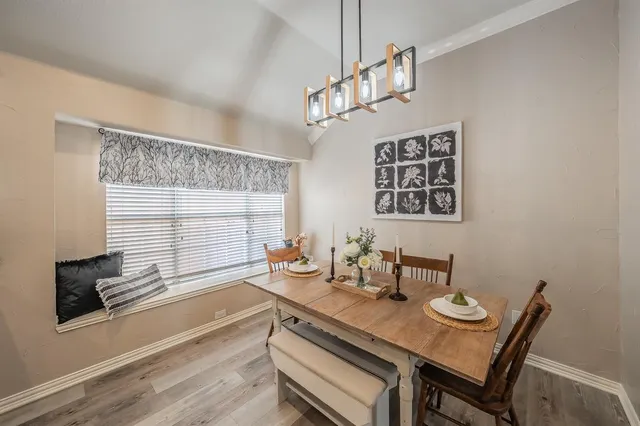 a large kitchen with a table and chairs