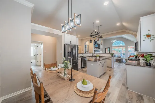 a kitchen with kitchen island a sink and a stove top oven