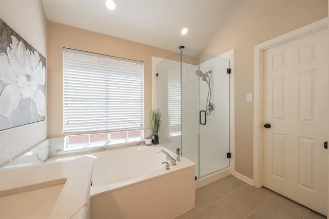 a bathroom with double vanity sinks and a bathtub