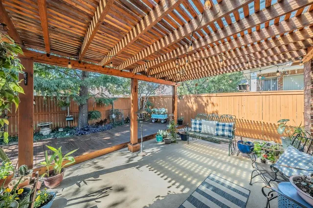 a view of a patio with table and chairs and potted plants
