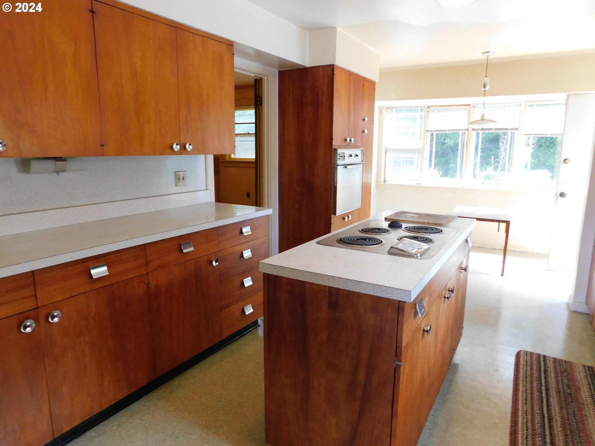 150 North Dean Street Coquille, OR 97423 - Photo 21 of 47 a kitchen with stainless steel appliances kitchen island wooden cabinets a refrigerator and a stove