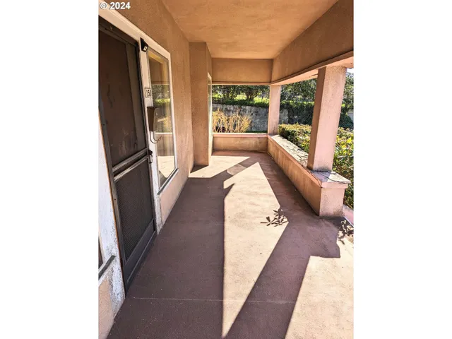 a living room with furniture and large windows