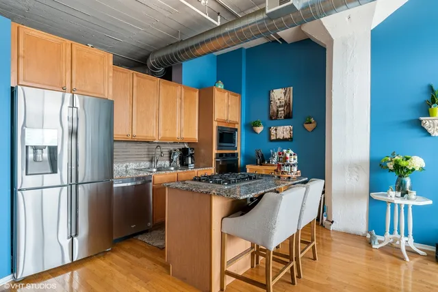 a living room with furniture a wooden floor and a large window