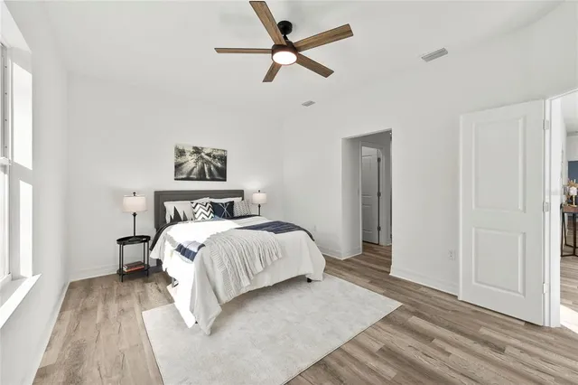 a bedroom with a bed and a ceiling fan
