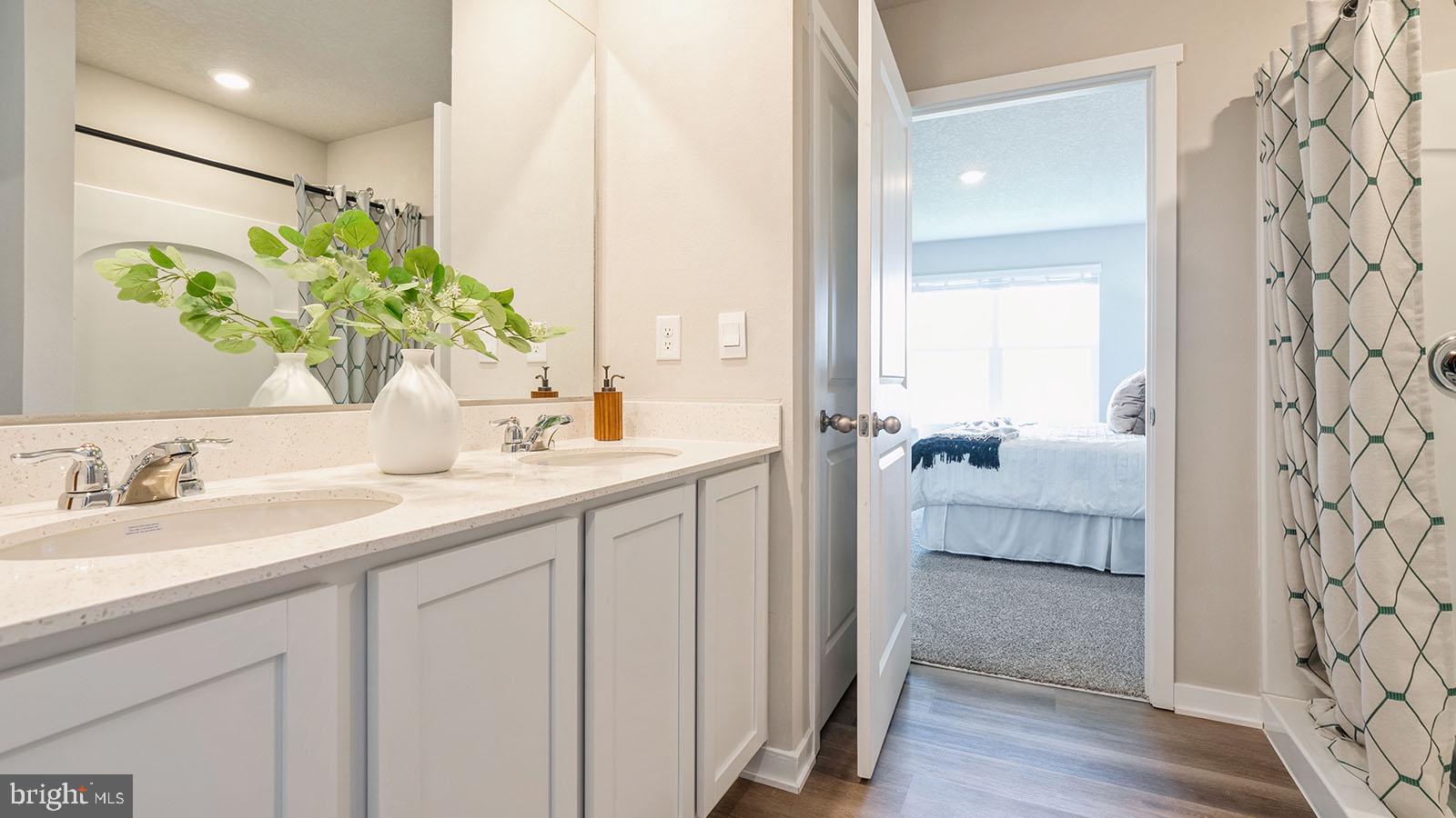 118 Erica Lane Columbia, PA 17512 - Photo 5 of 9 a en suite bathroom with a double vanity sink and mirror