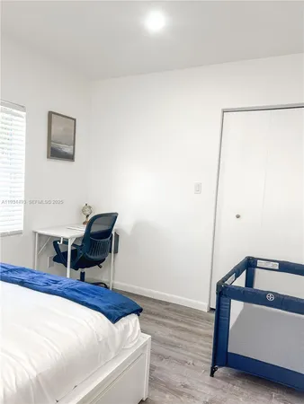 a bedroom with a bed and a workspace