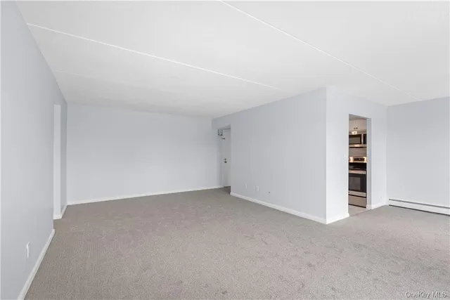 a view of an empty room with closet