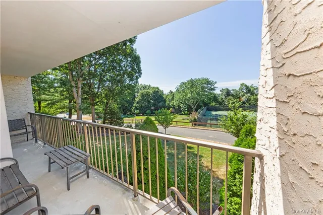 a view of a balcony with wooden floor
