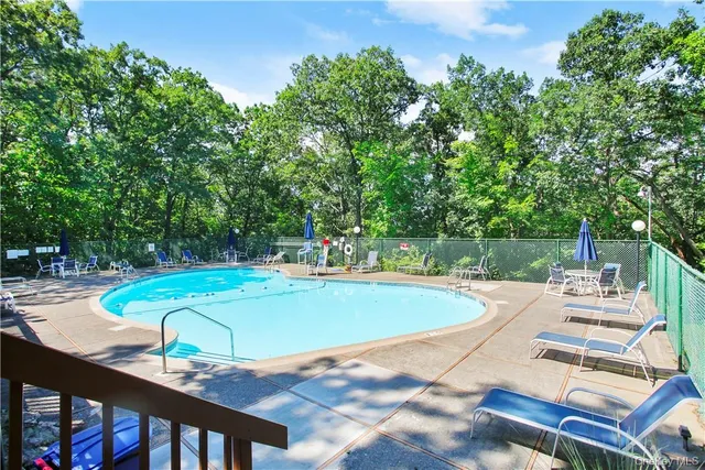 a view of a swimming pool with lounge chairs