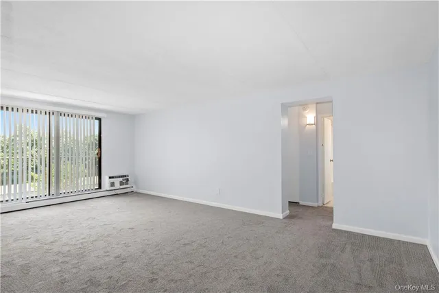 a view of an empty room with glass door