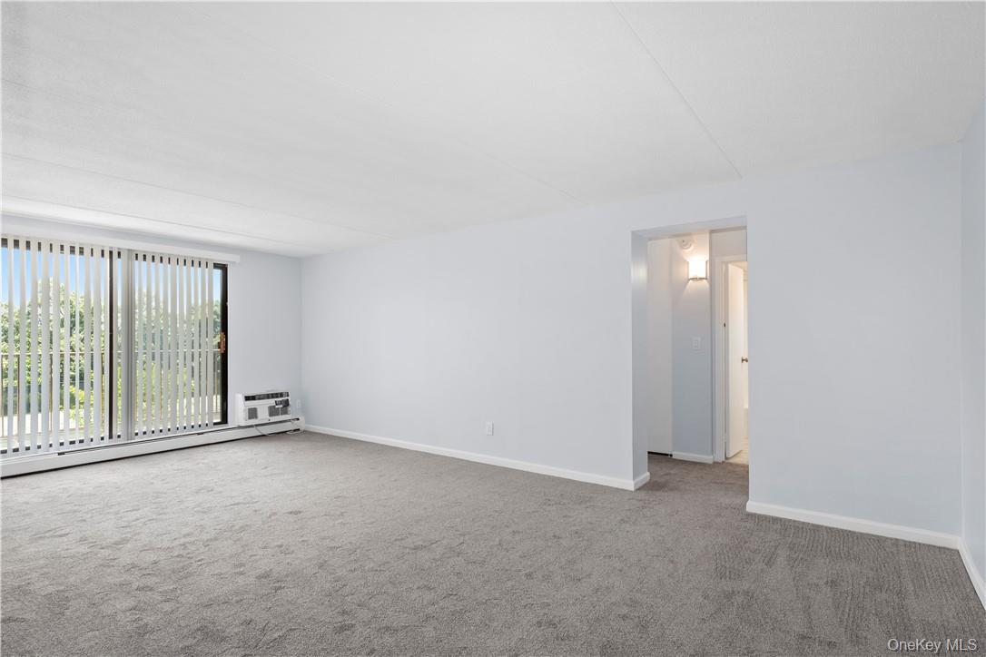 150 Overlook Avenue, Unit 1S Peekskill, NY 10566 - Photo 3 of 23 a view of an empty room with glass door