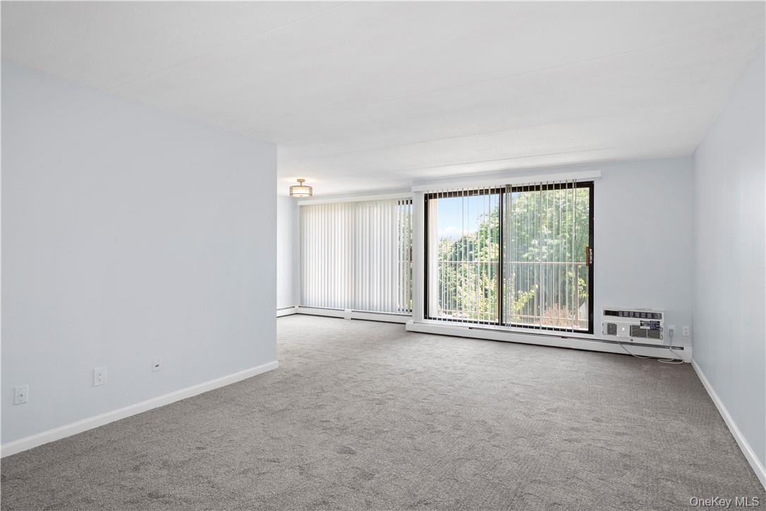 150 Overlook Avenue, Unit 1S Peekskill, NY 10566 - Photo 5 of 23 an empty room with large windows