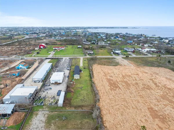 a small pool with a yard and plants