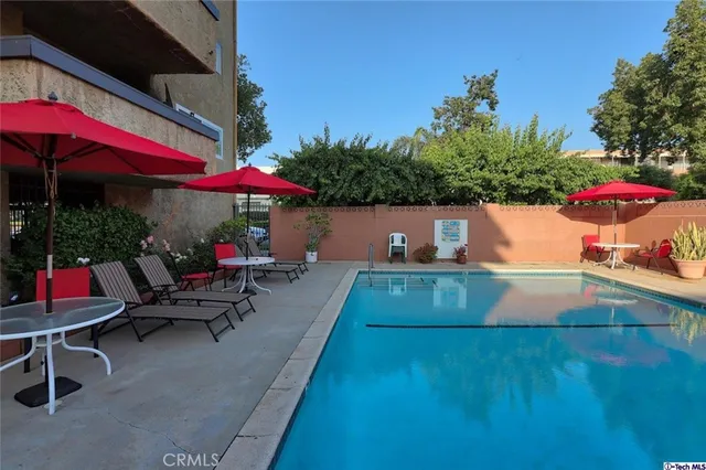 an outdoor sitting area with an umbrella