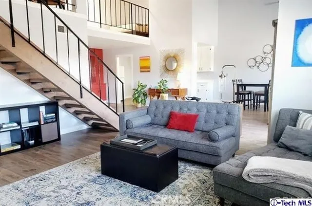 a living room with furniture or stairs and a wooden floor
