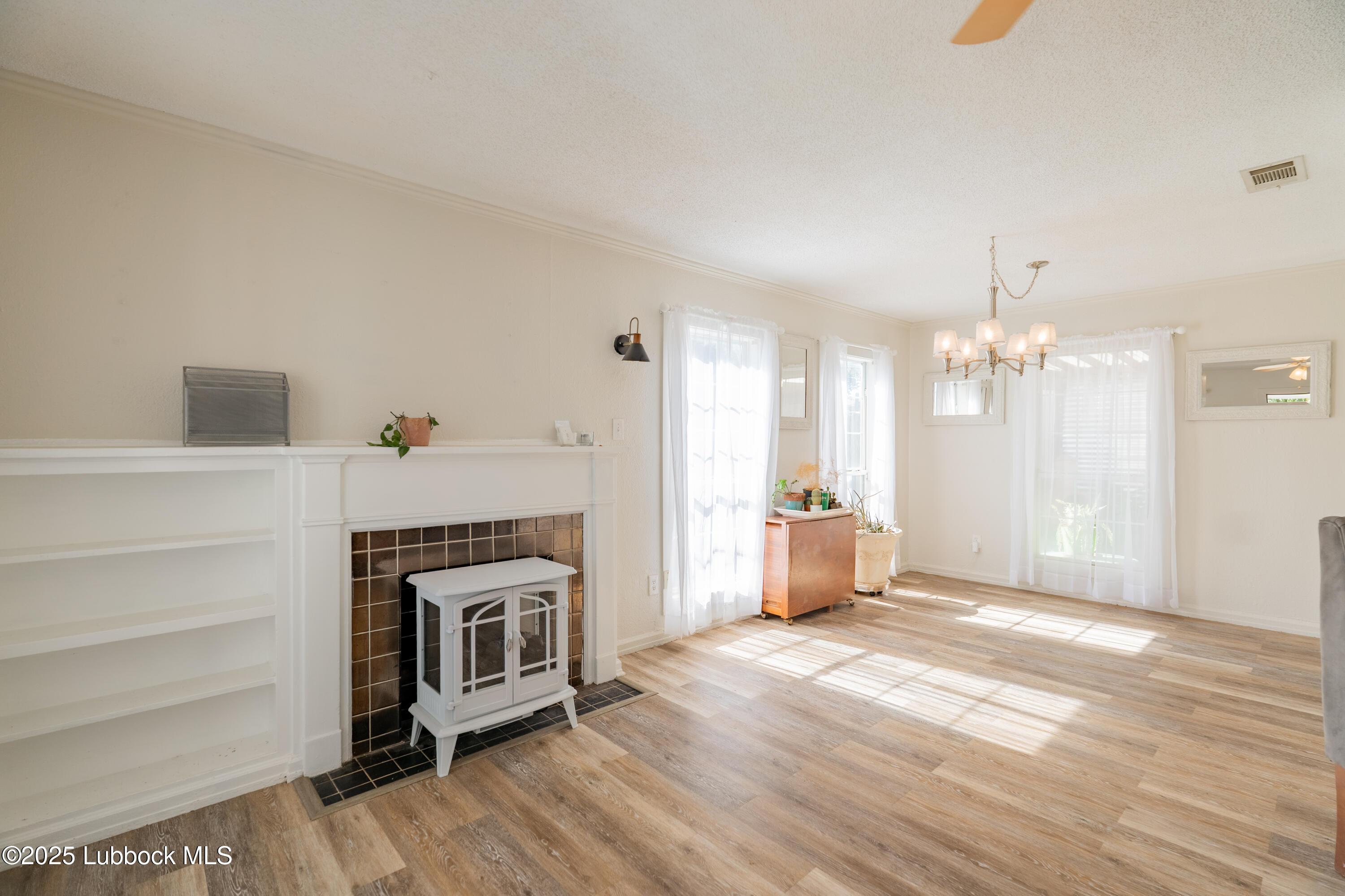 2012 29th Street Lubbock, TX 79411 - Photo 11 of 27 a view of a livingroom with a fireplace and window