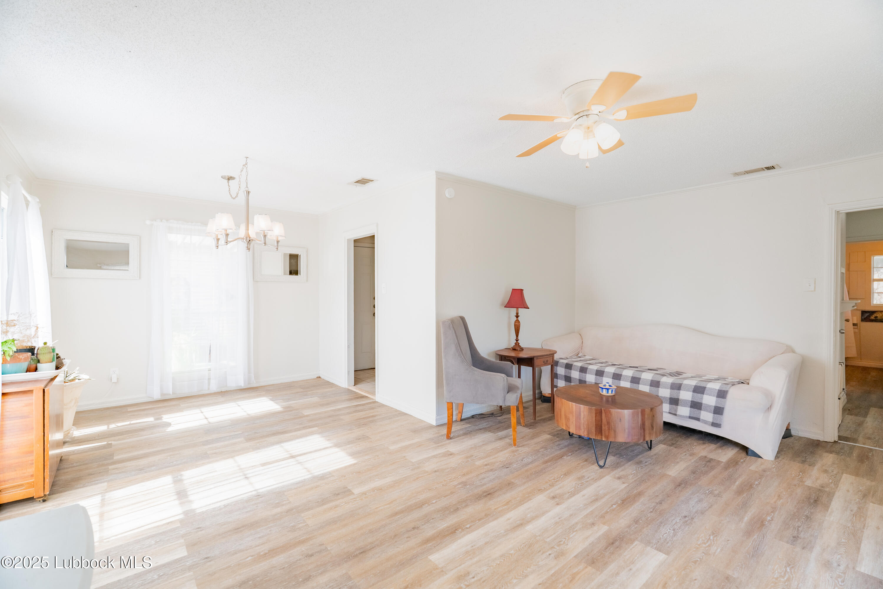 2012 29th Street Lubbock, TX 79411 - Photo 12 of 27 a living room with furniture and a wooden floor