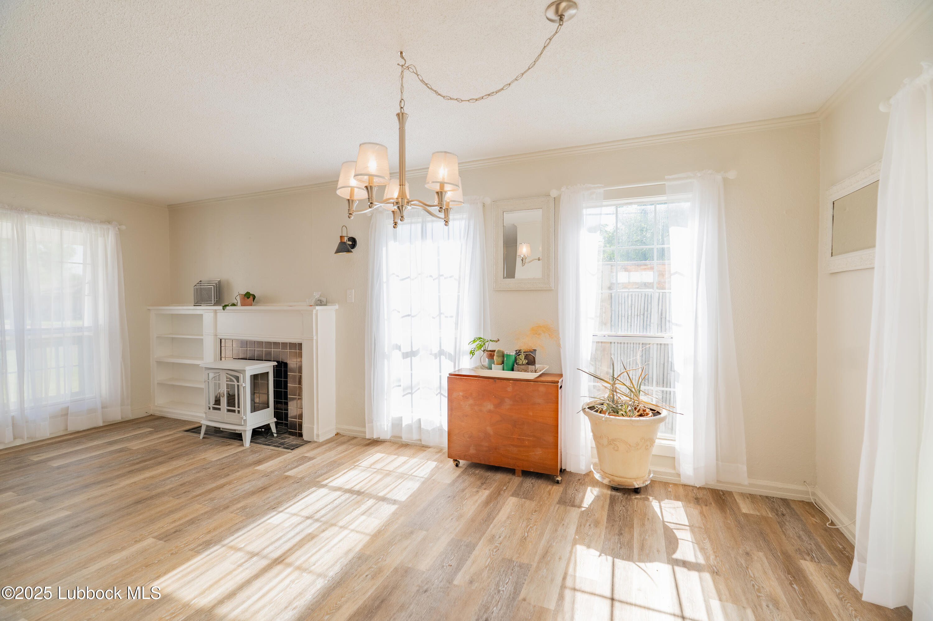 2012 29th Street Lubbock, TX 79411 - Photo 15 of 27 a view of a livingroom with a furniture wooden floor and a window