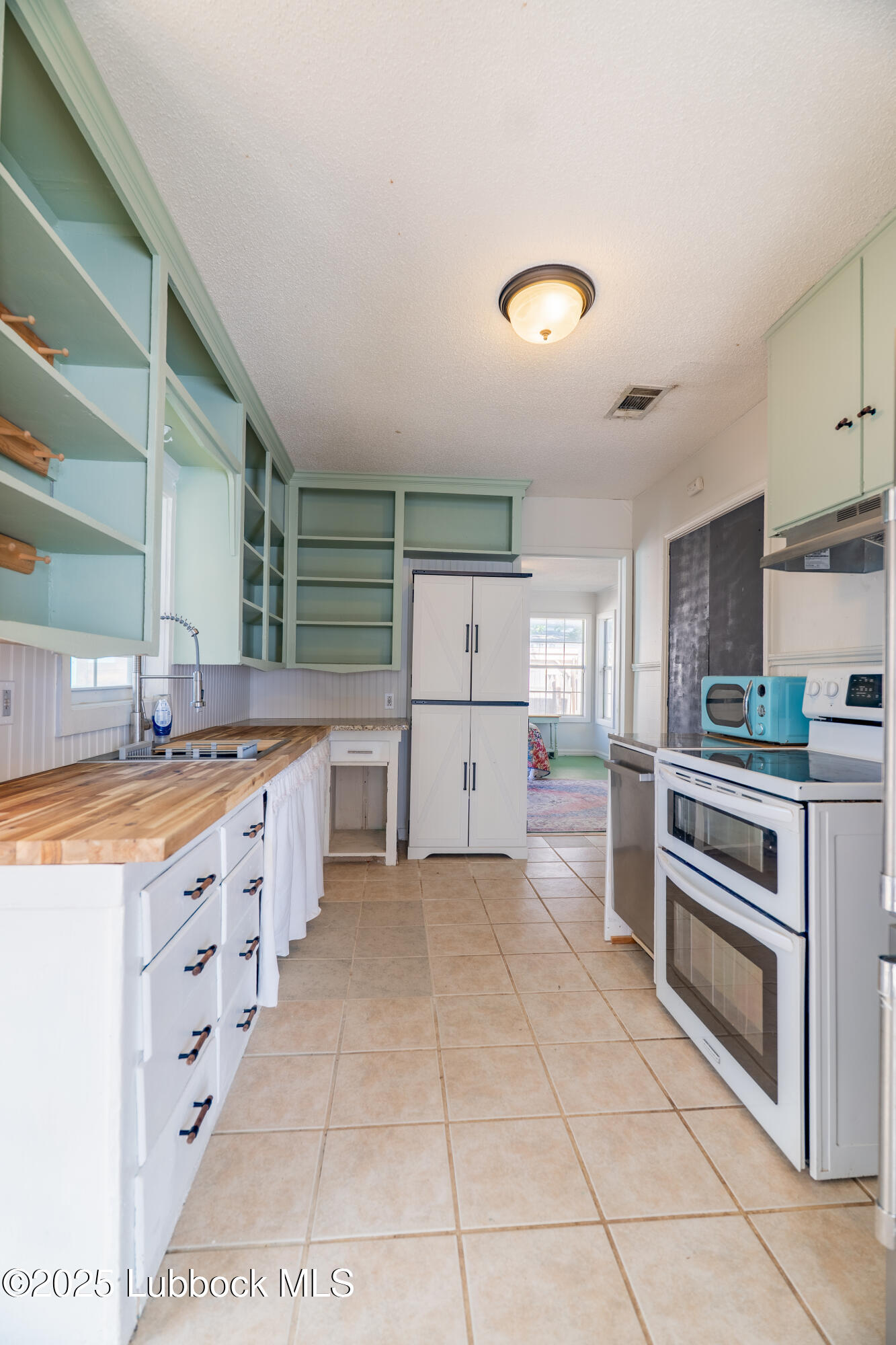 2012 29th Street Lubbock, TX 79411 - Photo 18 of 27 a large kitchen with stainless steel appliances and cabinets