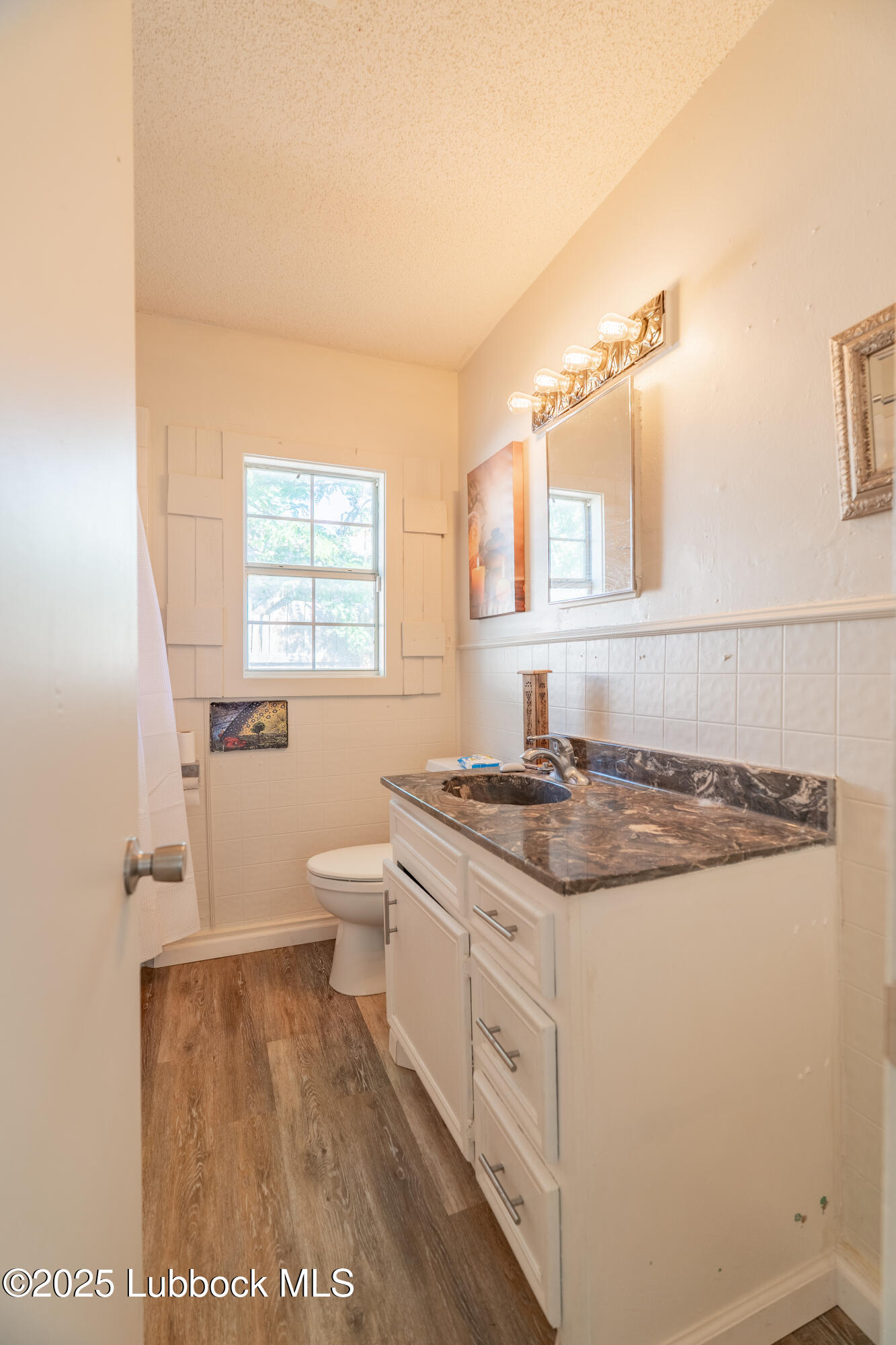 2012 29th Street Lubbock, TX 79411 - Photo 24 of 27 a kitchen with a stove a sink and a window