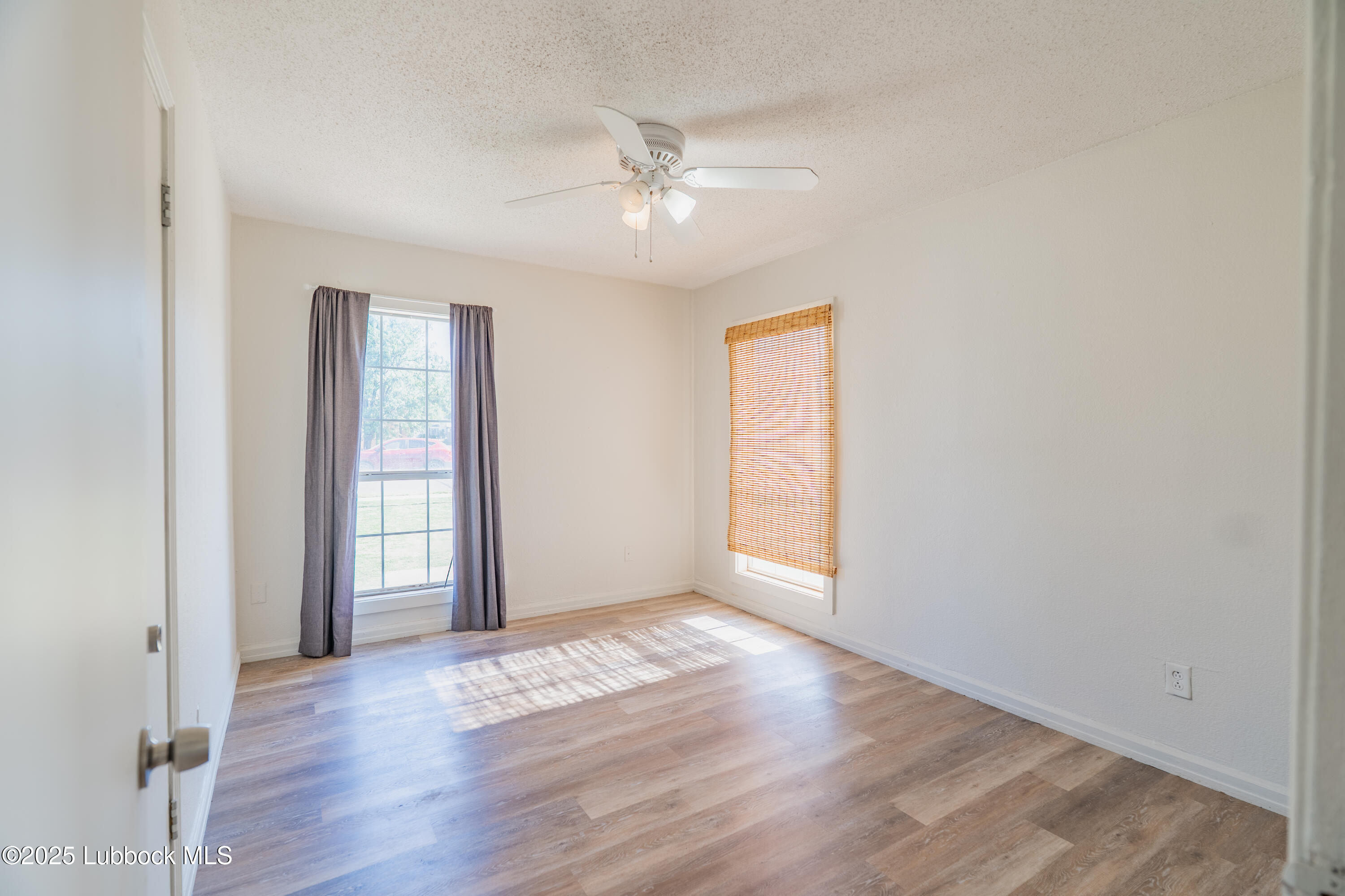 2012 29th Street Lubbock, TX 79411 - Photo 26 of 27 an empty room with wooden floor and windows