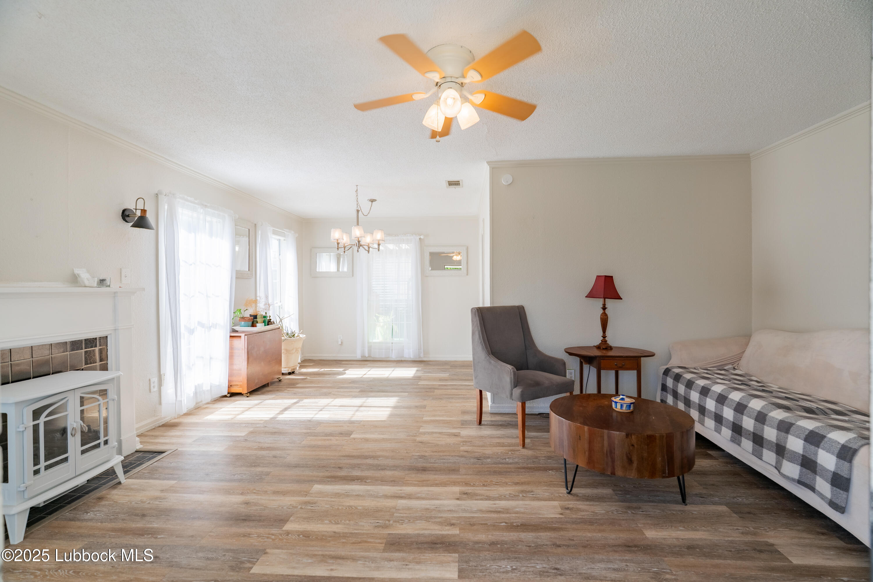 2012 29th Street Lubbock, TX 79411 - Photo 10 of 27 a view of a dining room with furniture and a chandelier
