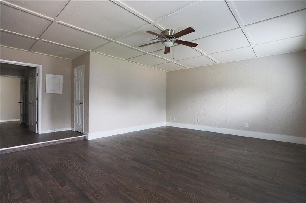 1410 Ransom Street Pflugerville, TX 78660 - Photo 15 of 22 an empty room with wooden floor fan and windows