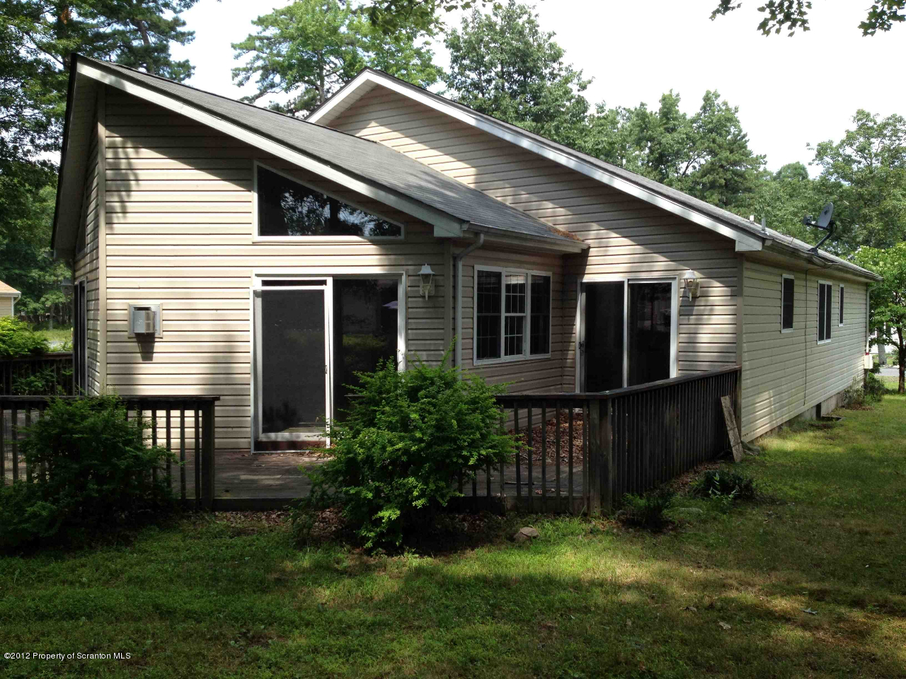 130 Gandolf Road Bushkill, PA 18324 - Photo 3 of 13 a view of backyard with potted plants and large tree