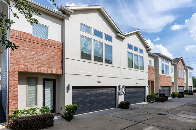 a front view of a building with garage