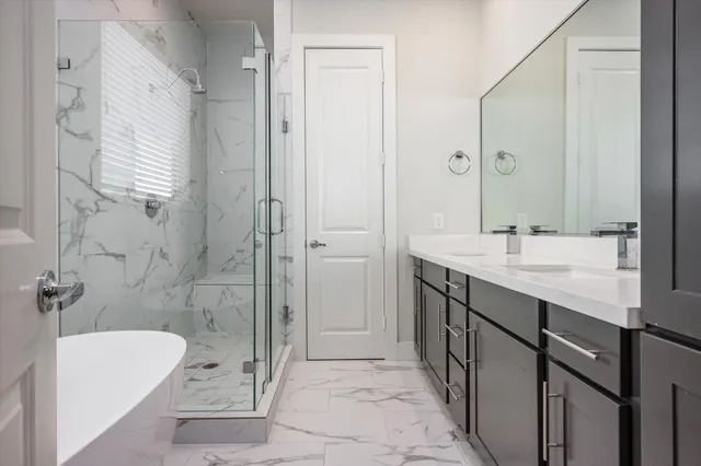 a bathroom with a granite countertop sink a toilet a mirror and bathtub
