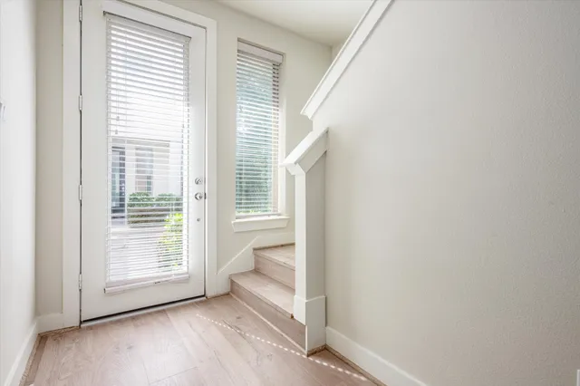 a view of wooden floor and windows in a room