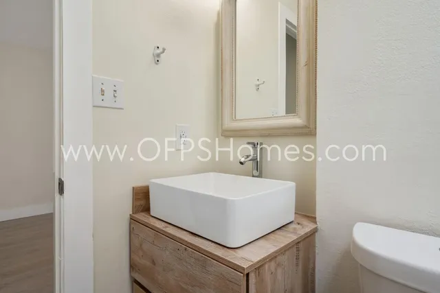 a bathroom with a sink a toilet and a mirror