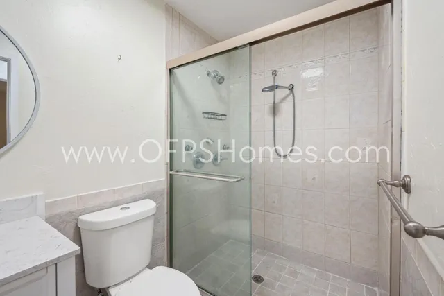 a bathroom with a shower toilet and sink