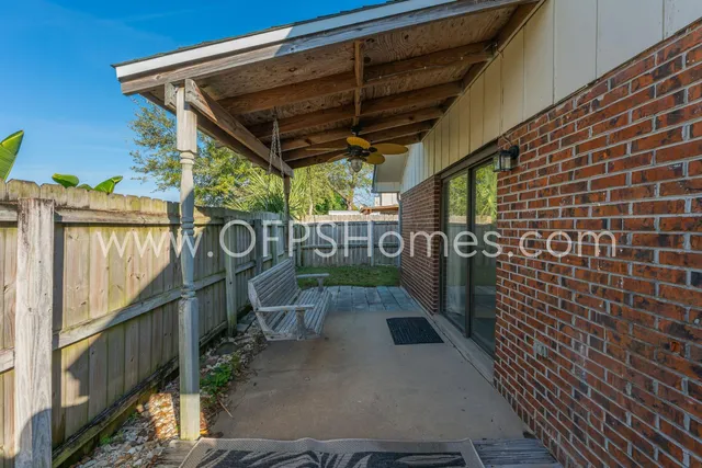 a view of a patio with table and chairs
