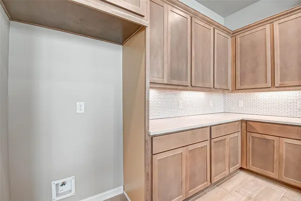 a kitchen with white cabinets and white appliances