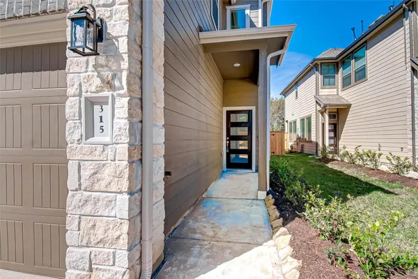 a view of a brick house with a yard