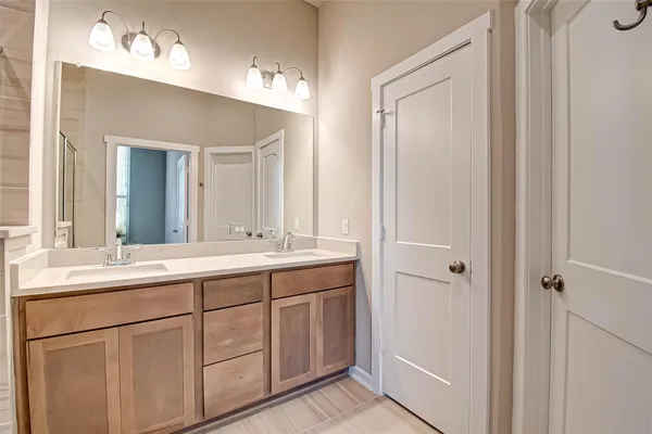 a bathroom with a double vanity sink and mirror