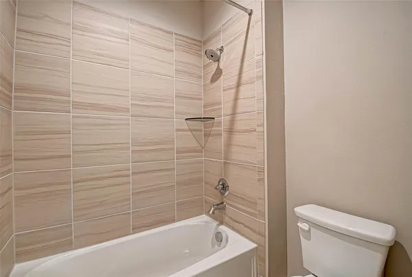 a bathroom with a shower and a toilet