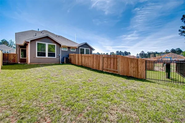 a view of a house with wooden fence
