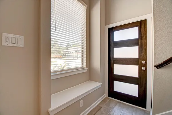 a bathroom with a bathtub and a window