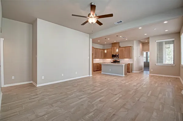 a view of a kitchen with a sink and a ceiling fan