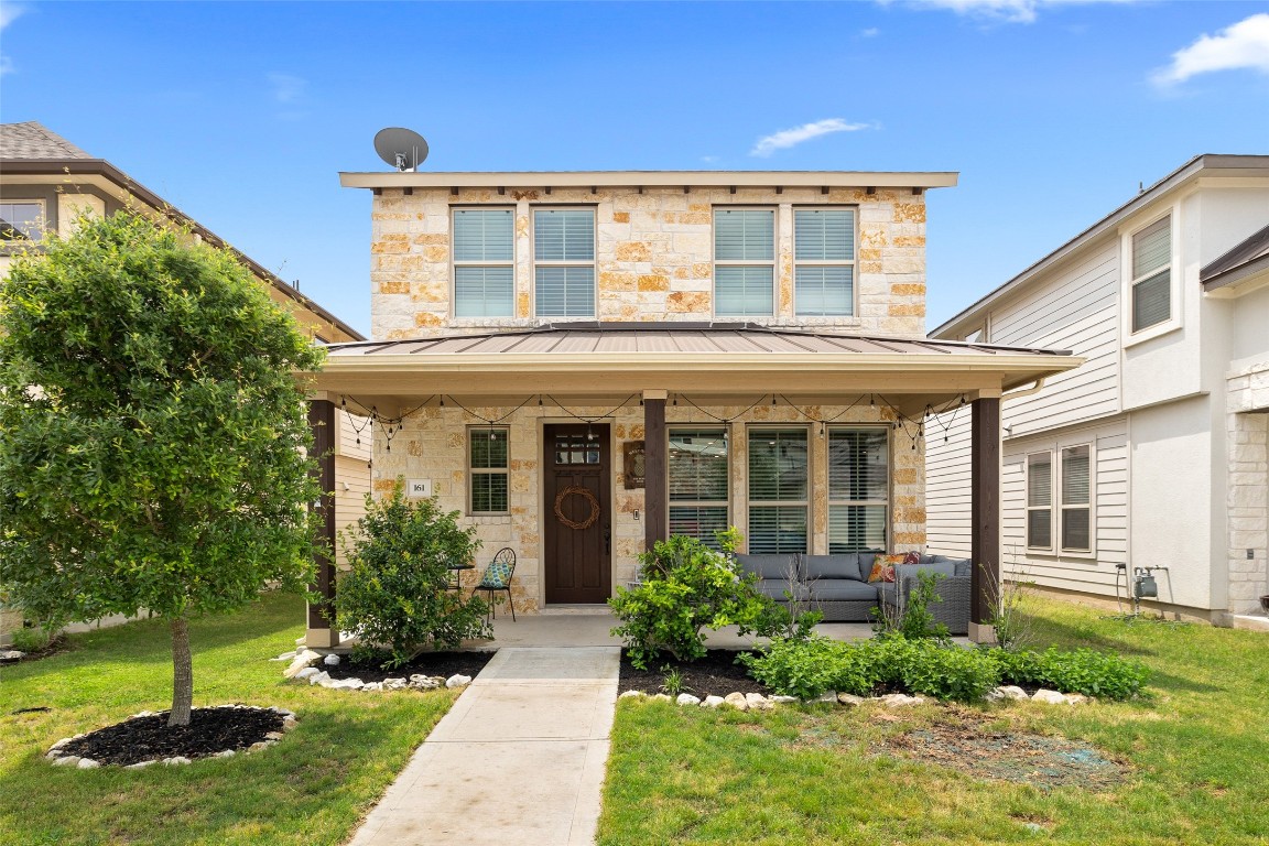 a front view of a house with a yard and porch