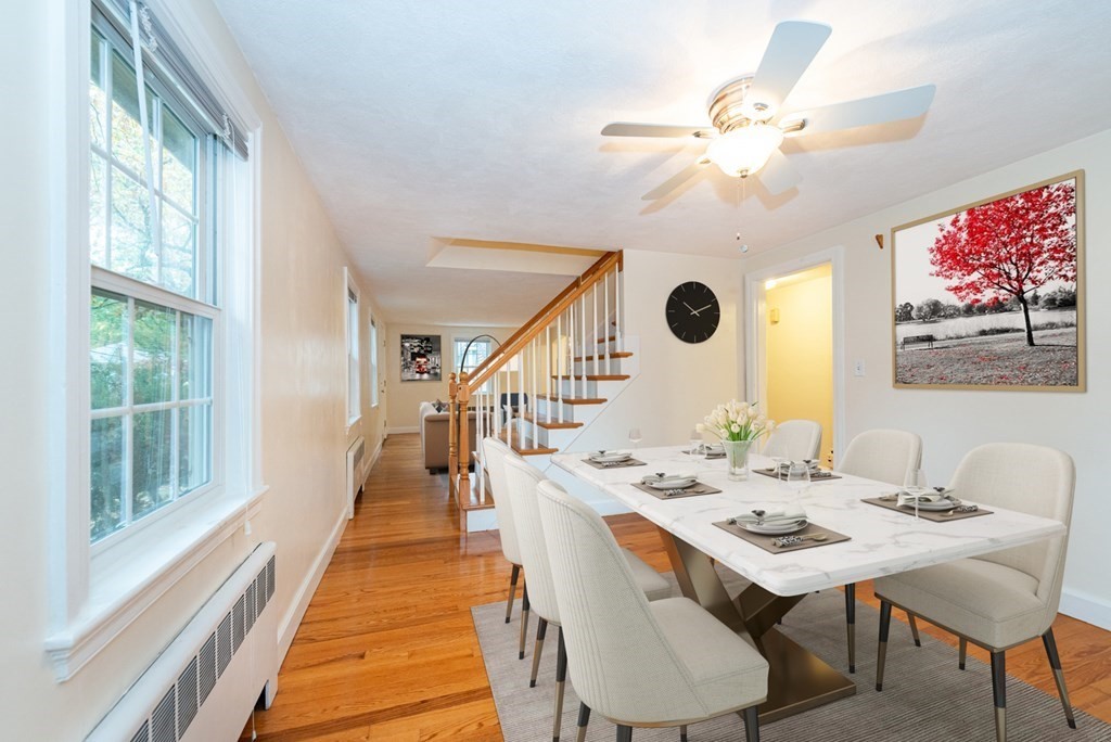 62 Spring Street Lexington, MA 02421 - Photo 11 of 32 a dining room with wooden floor and a chandelier